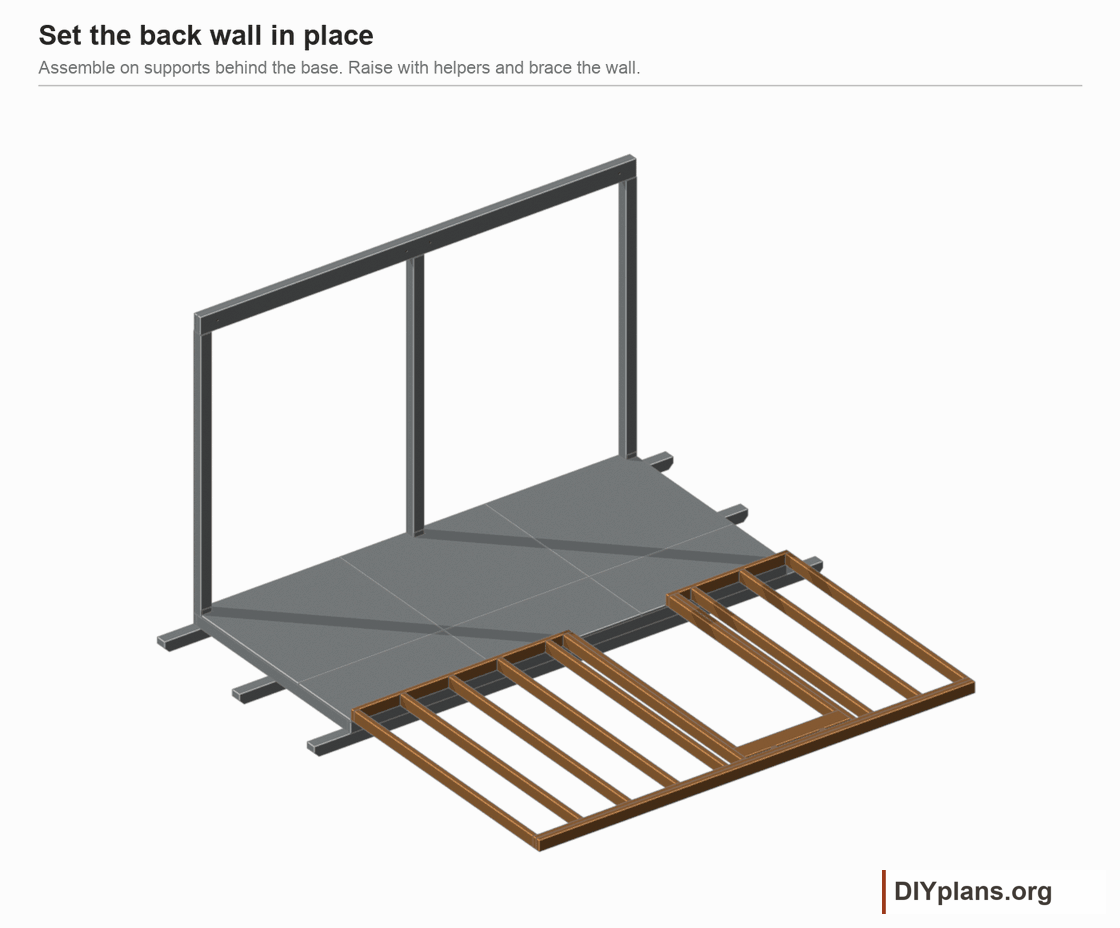 Raise the completed back wall from supports behind the base, then brace it plumb.